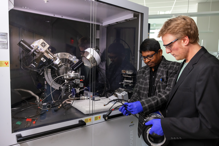 A student being taught how to use a machine.